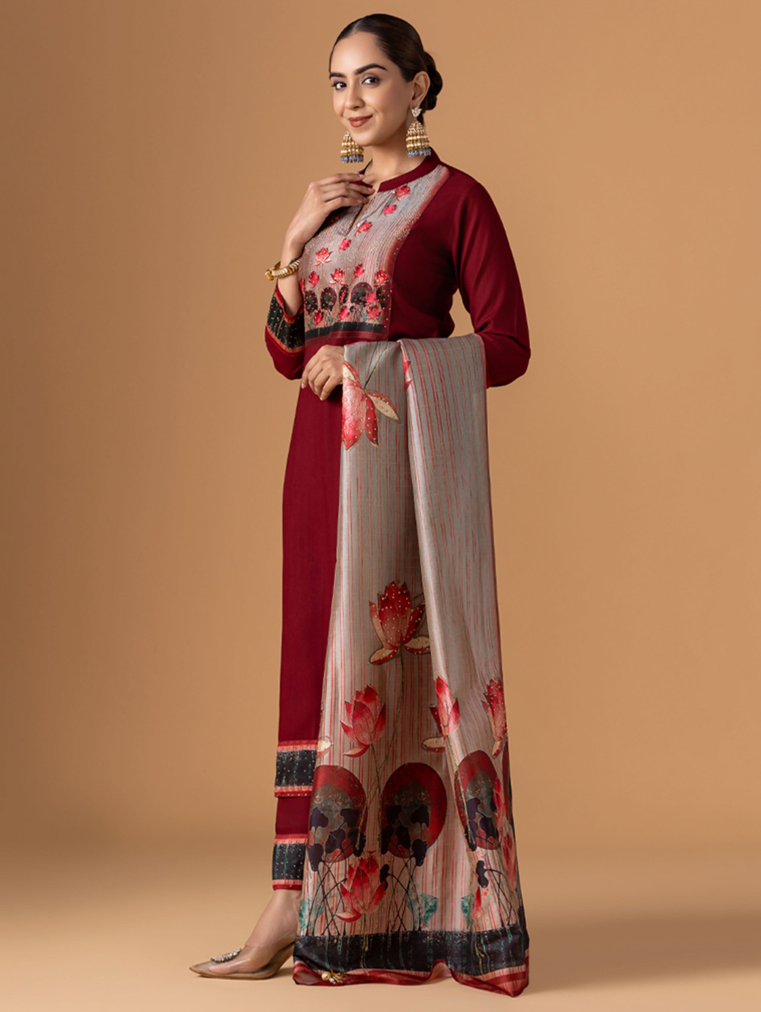 Woman wearing a red and white traditional outfit with floral patterns on a beige background