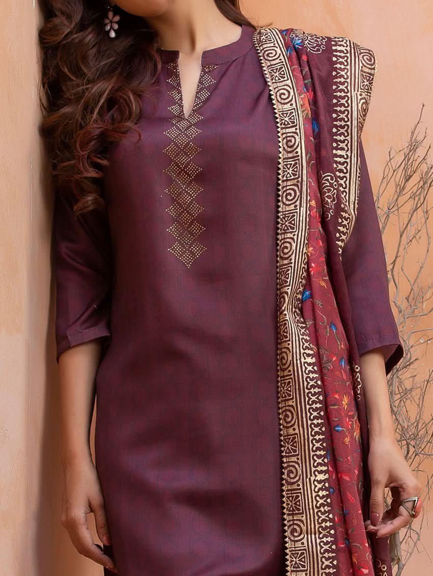 Purple embroidered kurta with a matching dupatta against a beige background