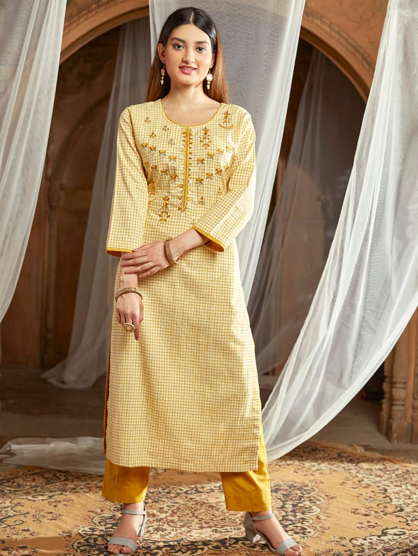Women wearing a Yellow checkered Kurta with round neckline and computer embroidered with three fourth sleeves