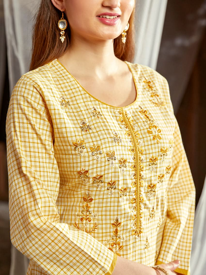 Women wearing a Yellow checkered Kurta with round neckline and computer embroidered with three fourth sleeves