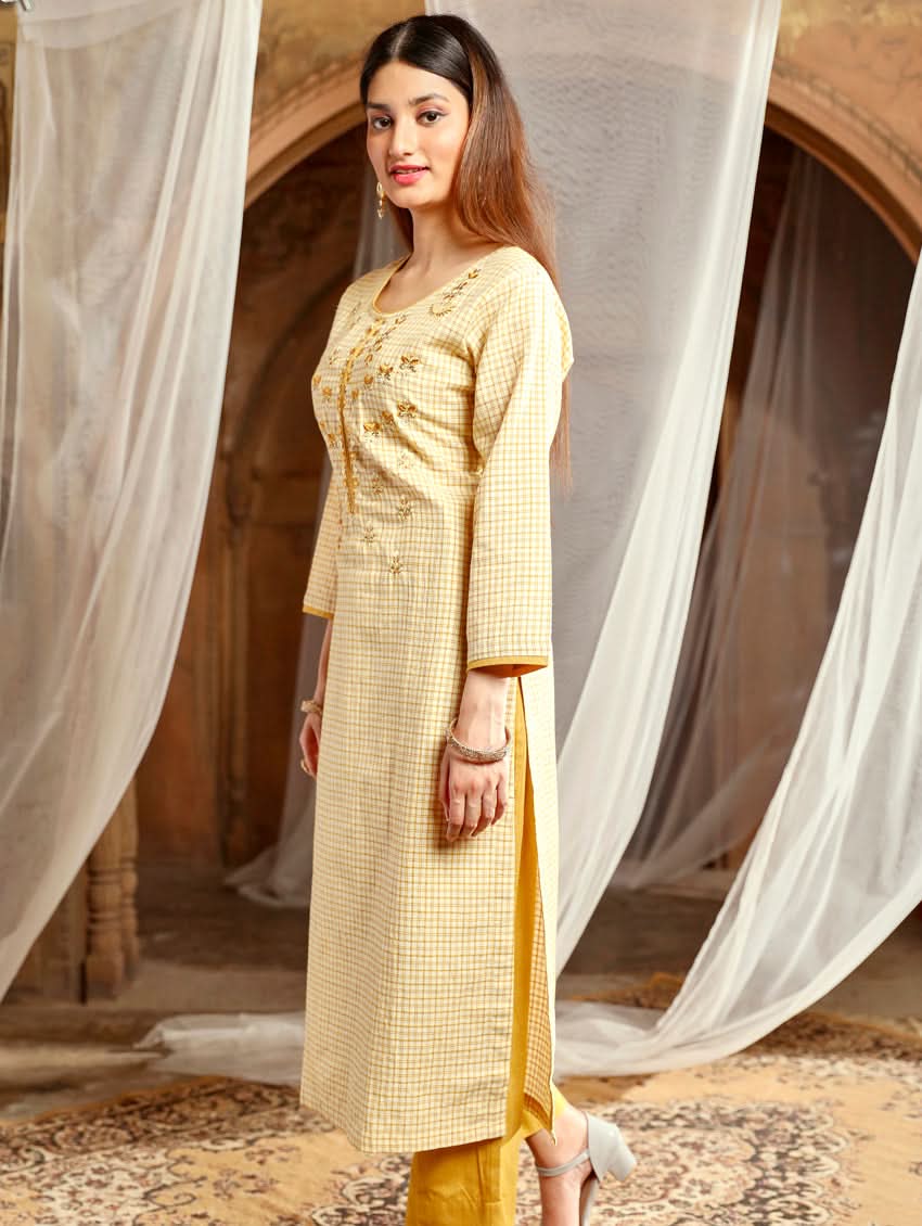 Women wearing a Yellow checkered Kurta with round neckline and computer embroidered with three fourth sleeves