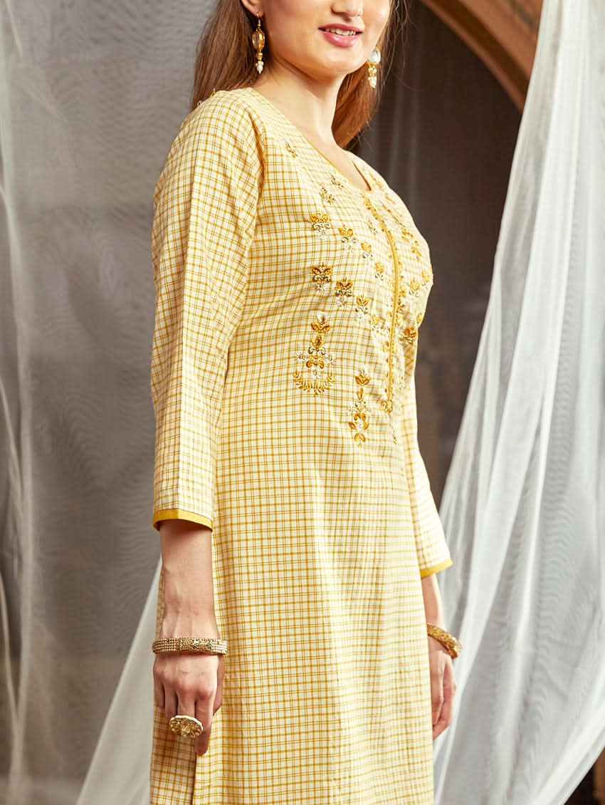 Women wearing a Yellow checkered Kurta with round neckline and computer embroidered with three fourth sleeves