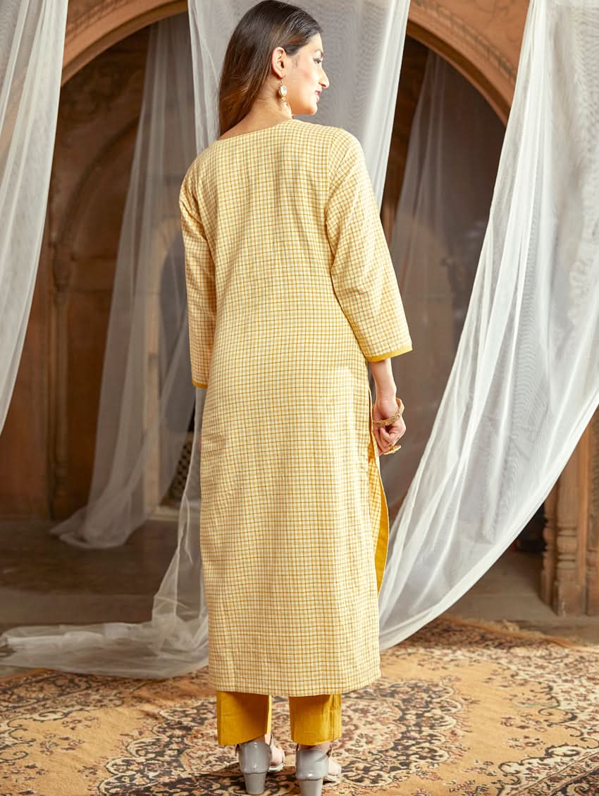 Women wearing a Yellow checkered Kurta with round neckline and computer embroidered with three fourth sleeves