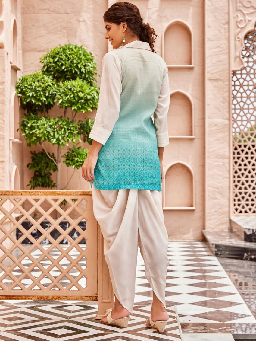 A woman standing outdoors wearing an printed cotton co-ord set with a rever neckline, three-quarter sleeves, and pockets on either side.