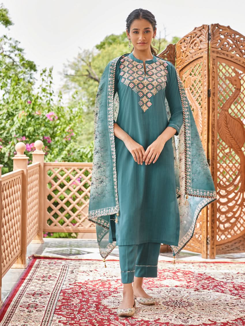 Teal embroidered silk kurta with matching pants and dupatta with decorative border