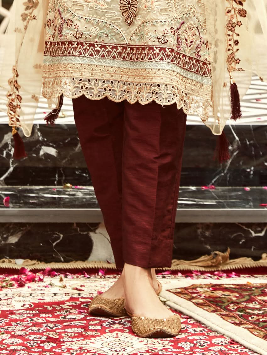 Maroon pants worn with cream embroidered tunic and sheer organza sleeves
