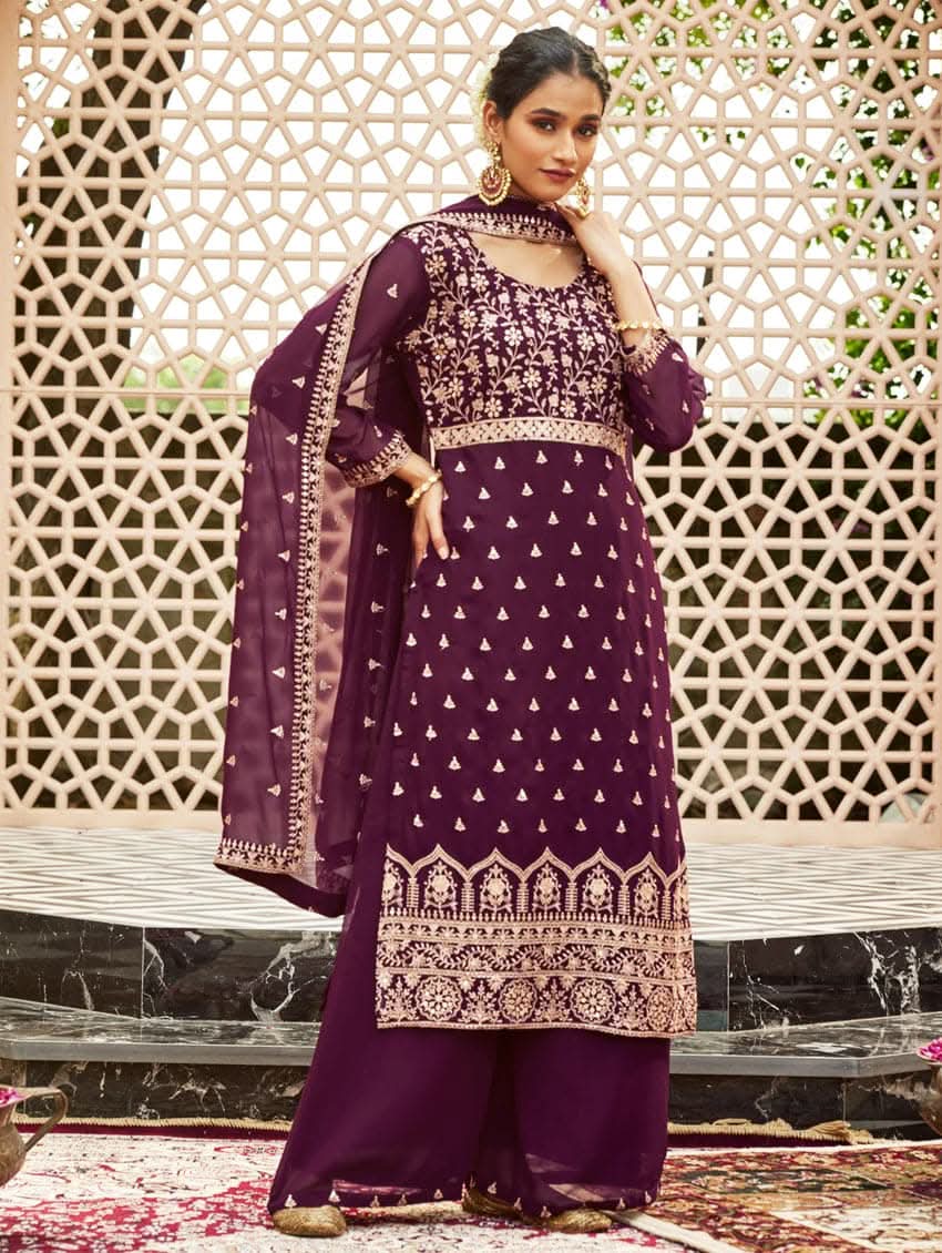 A woman wearing a traditional purple kurta set with embroidered details and a dupatta with a georget design, with dupatta