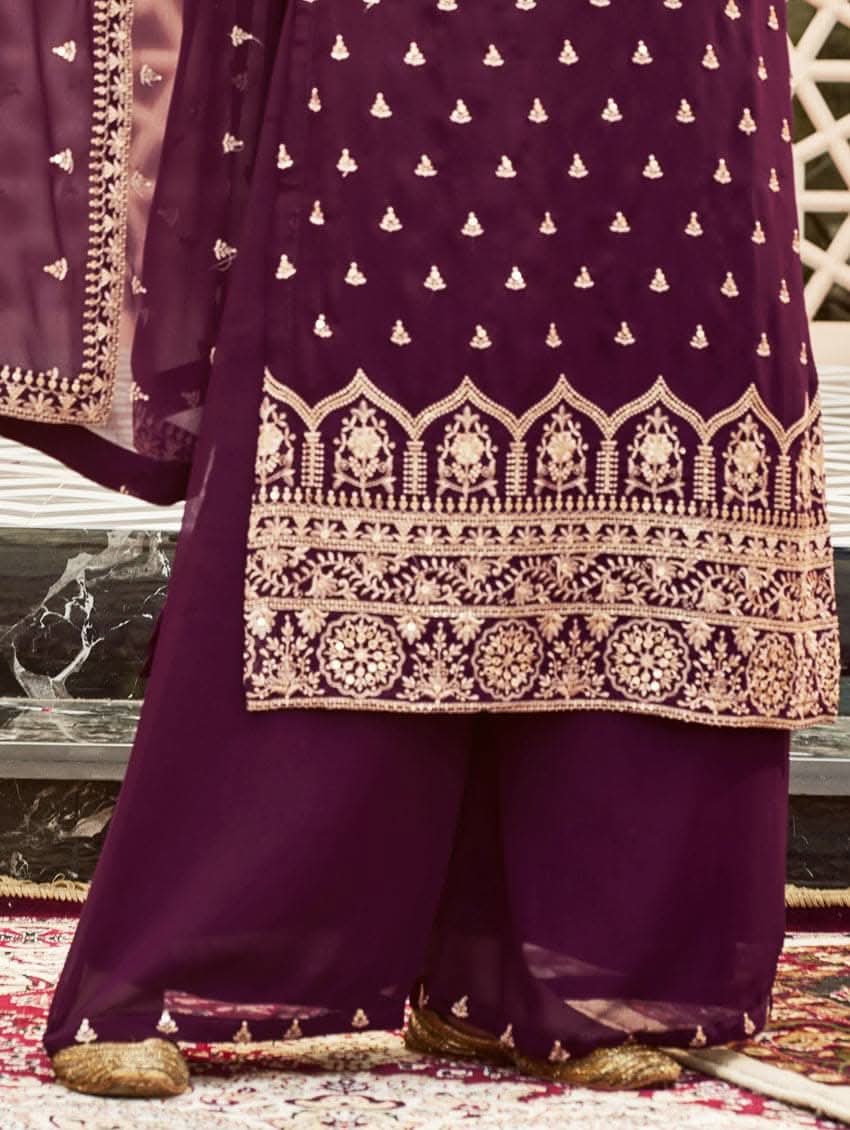 A woman wearing a traditional purple kurta set with embroidered details and a dupatta with a georget design, with dupatta