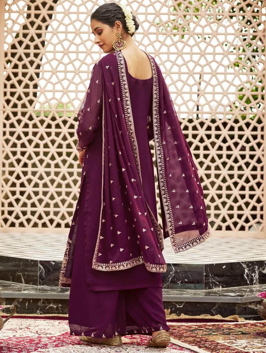 A woman wearing a traditional purple kurta set with embroidered details and a dupatta with a georget design, with dupatta