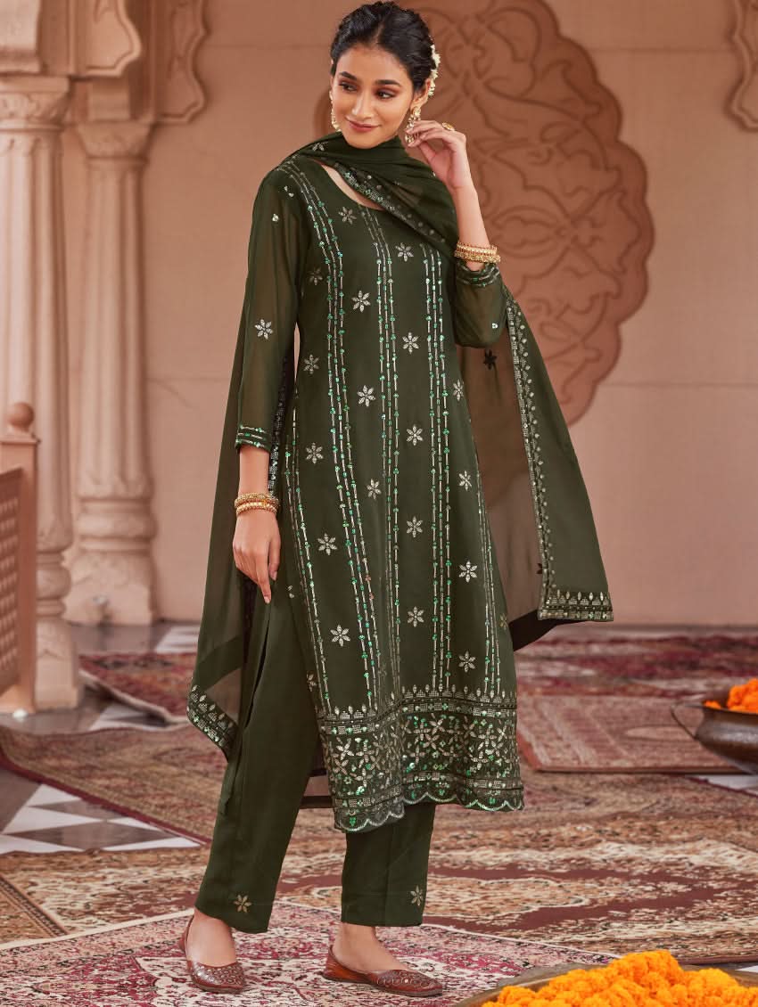 Dark green embroidered kurta with dupatta draped over shoulders and churidar pants