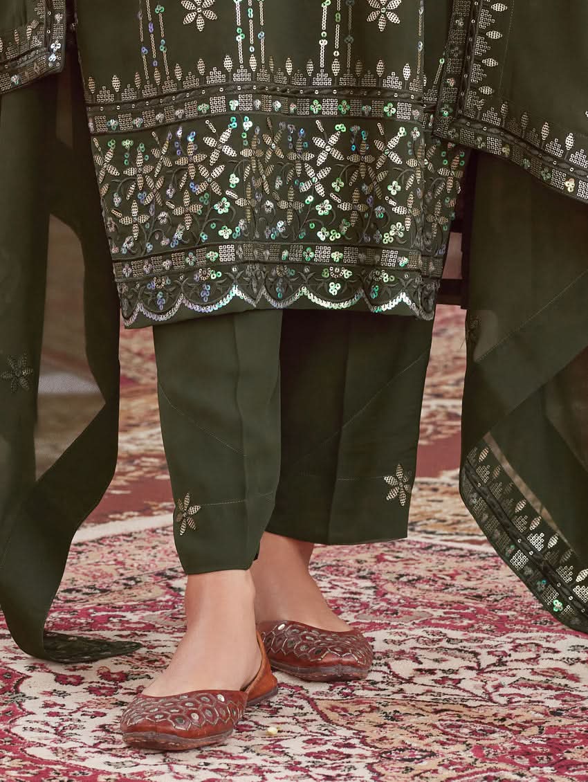 Dark green churidar pants with embroidered hem border and dupatta corner