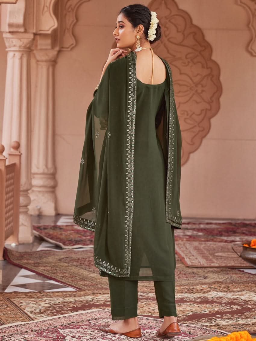 Dark green suit set with dupatta draped; open back neckline and embroidered motifs