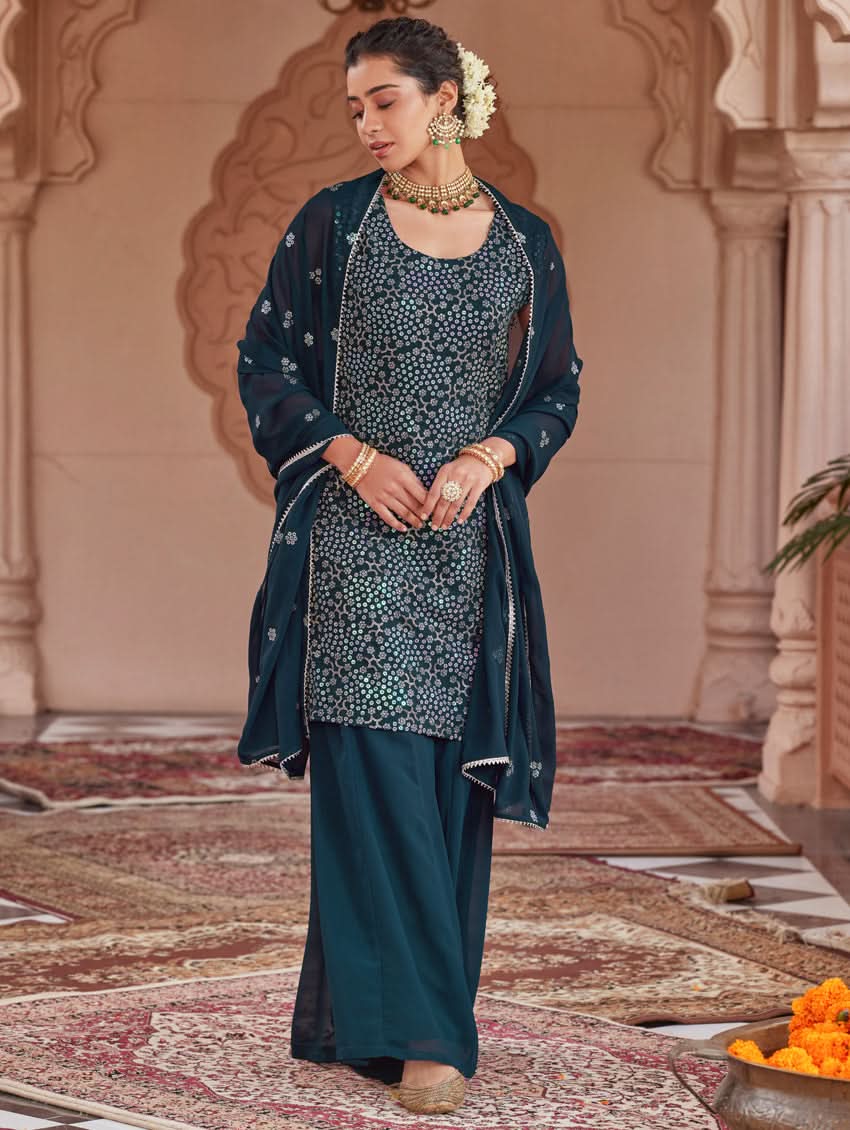 Embroidered dark teal sharara suit set with sleeveless tunic and layered flared pants