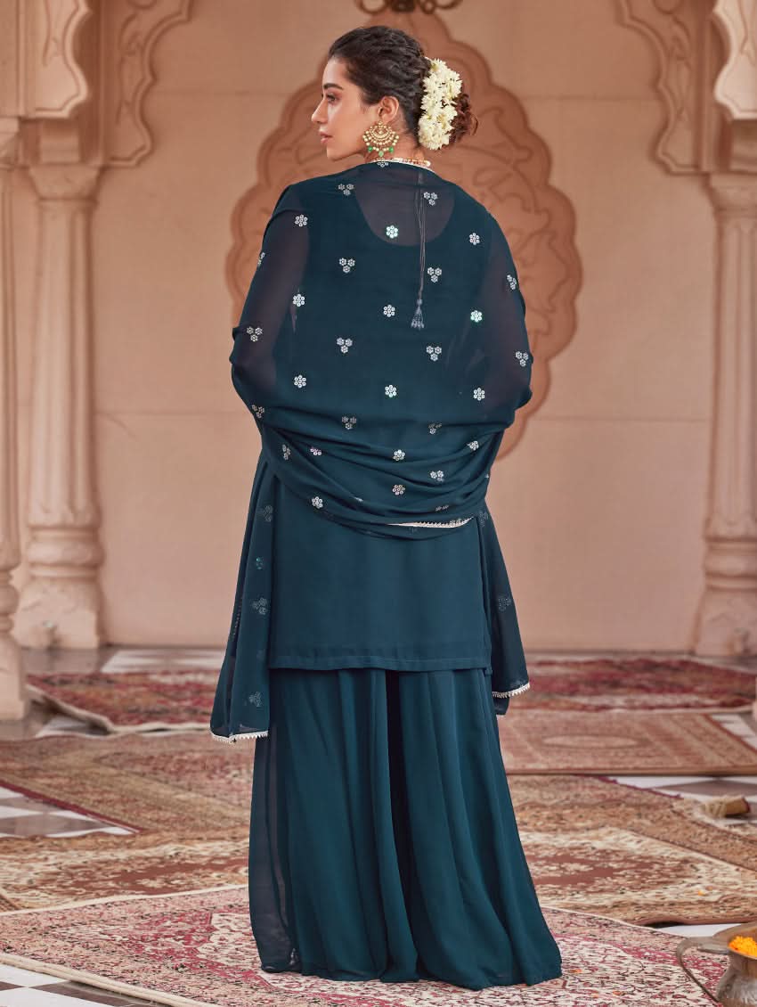 Back view of embroidered dark teal tunic with gathered dupatta and tiered sharara pants