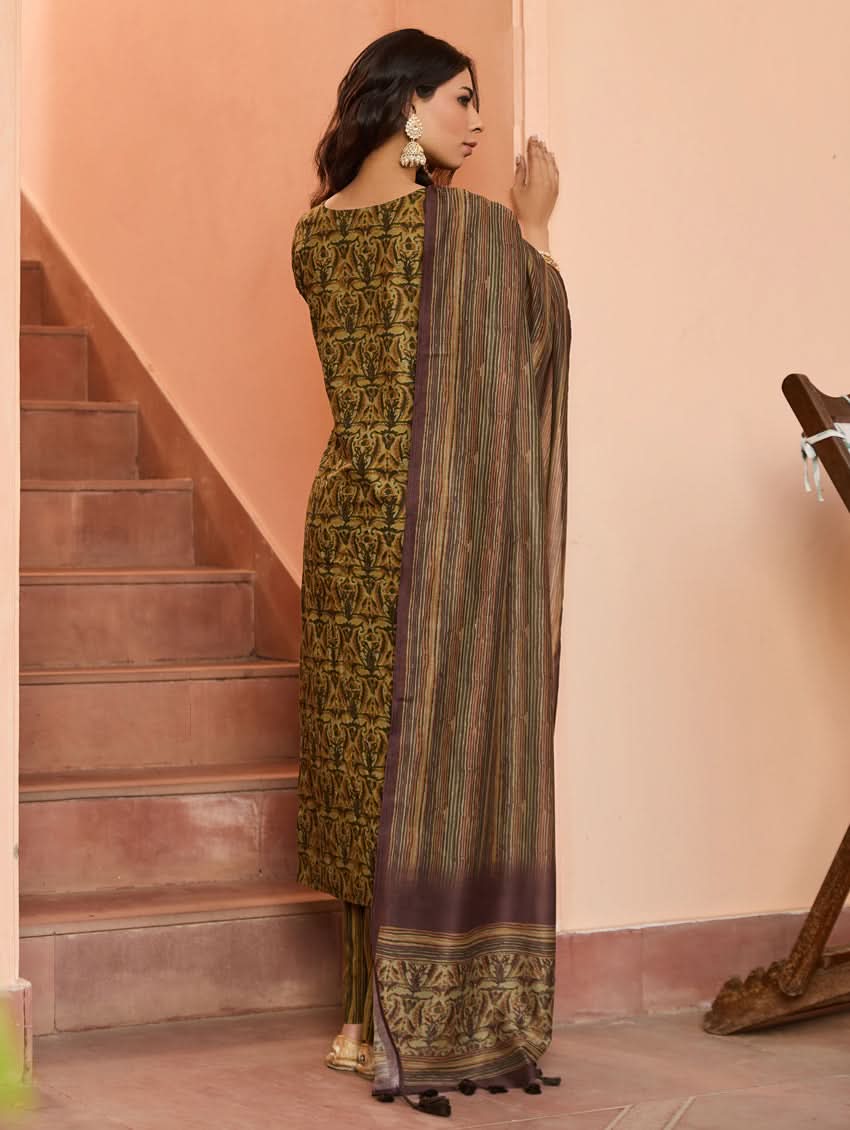 A woman wearing a traditional printed cotton suit set with a dupatta, featuring a boat neckline and embroidery details.