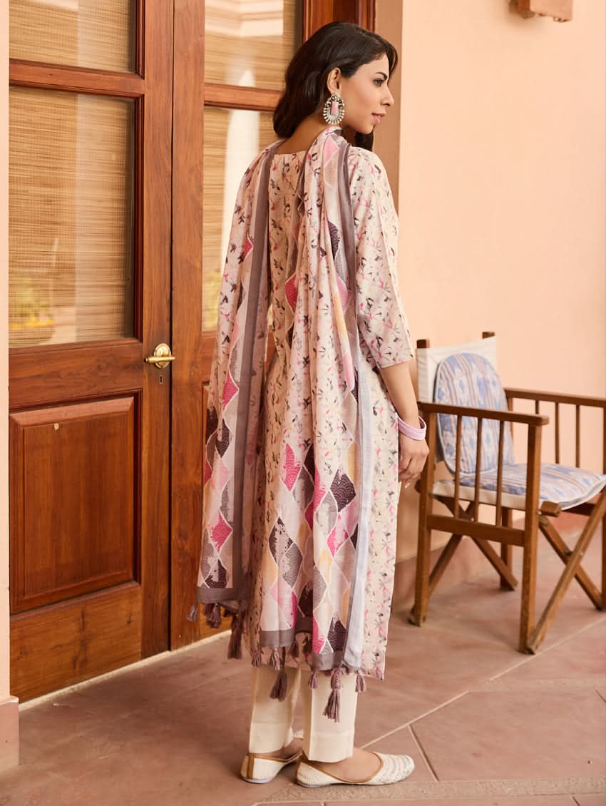 A woman standing outdoors wearing a digitally printed cotton suit set with a kurta, pants, and a dupatta in a floral pattern.