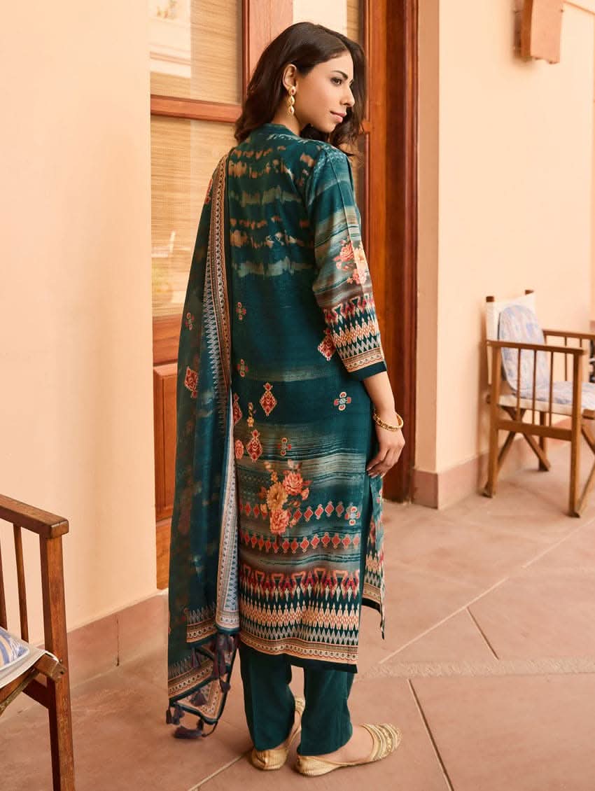 A woman wearing a blue viscose rayon suit set with hand embroidery on the kurta, consisting of a kurta with pants and a mul dupatta.