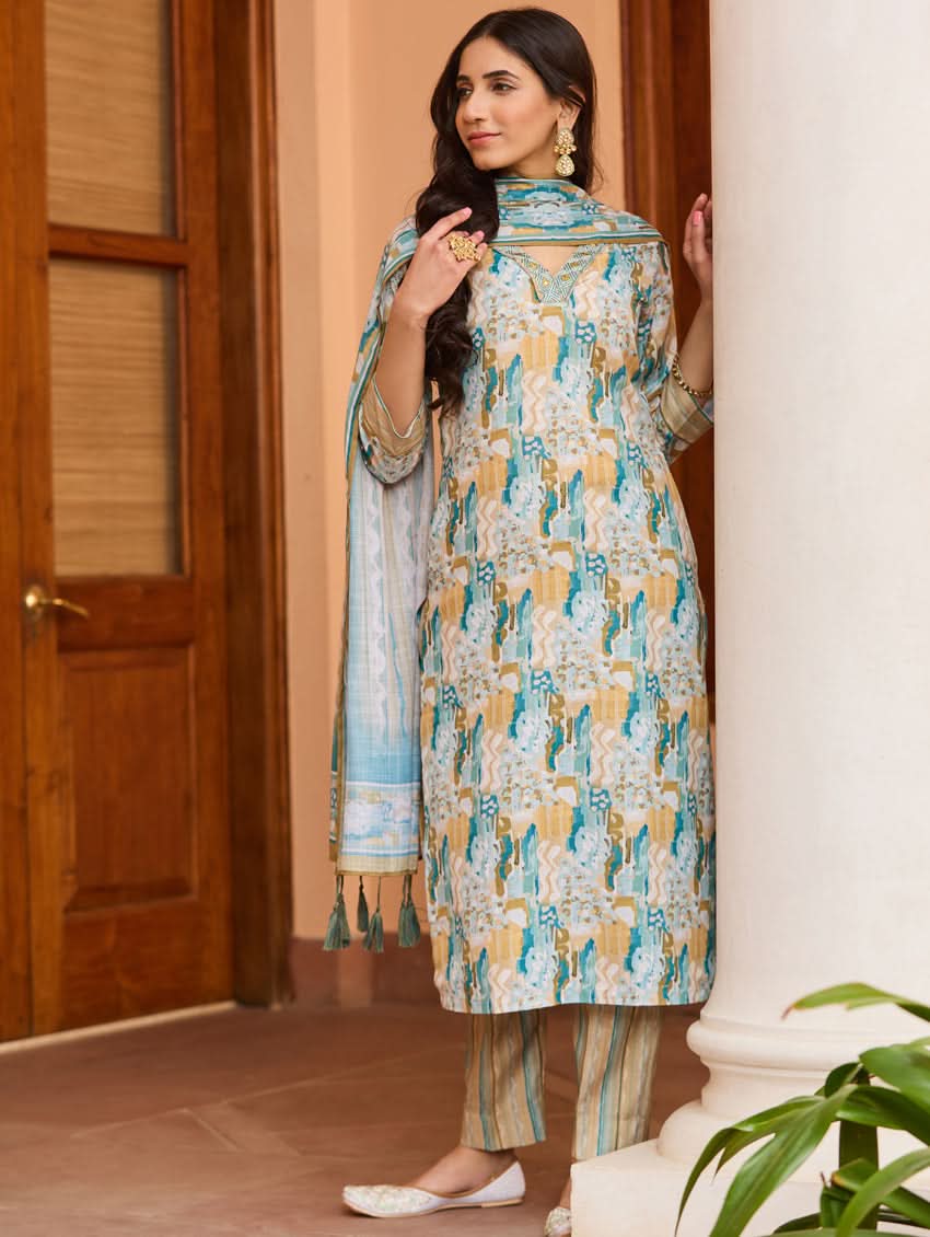 A woman wearing a printed cotton suit set with a dupatta, featuring a boat neckline and embroidery details.