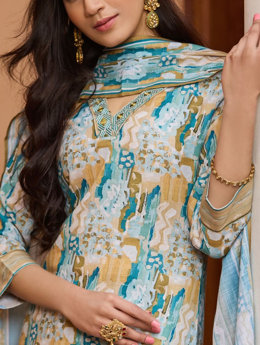 A woman wearing a printed cotton suit set with a dupatta, featuring a boat neckline and embroidery details.