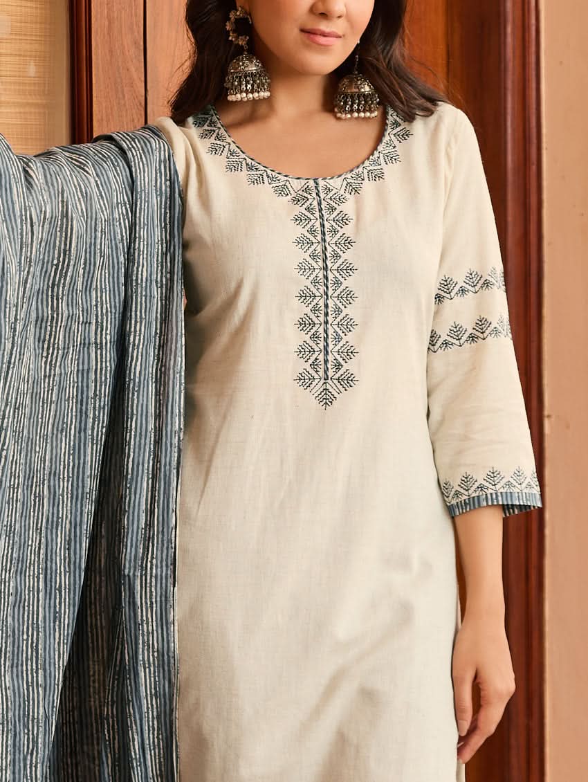 Cream tunic with center button-style embroidery and sleeve cuffs with blue motifs