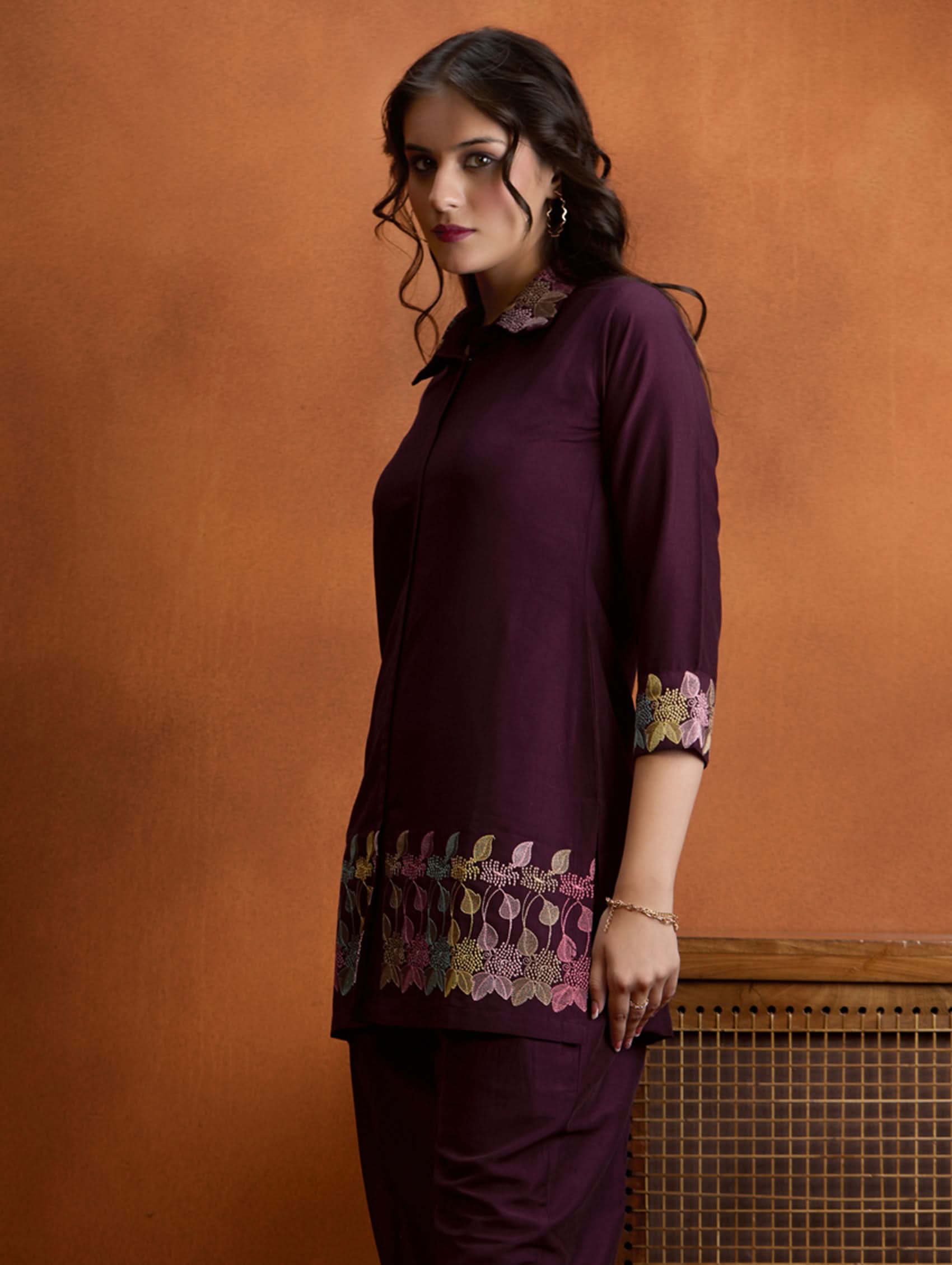 Dark maroon embroidered tunic top with floral cuff trim and straight hem