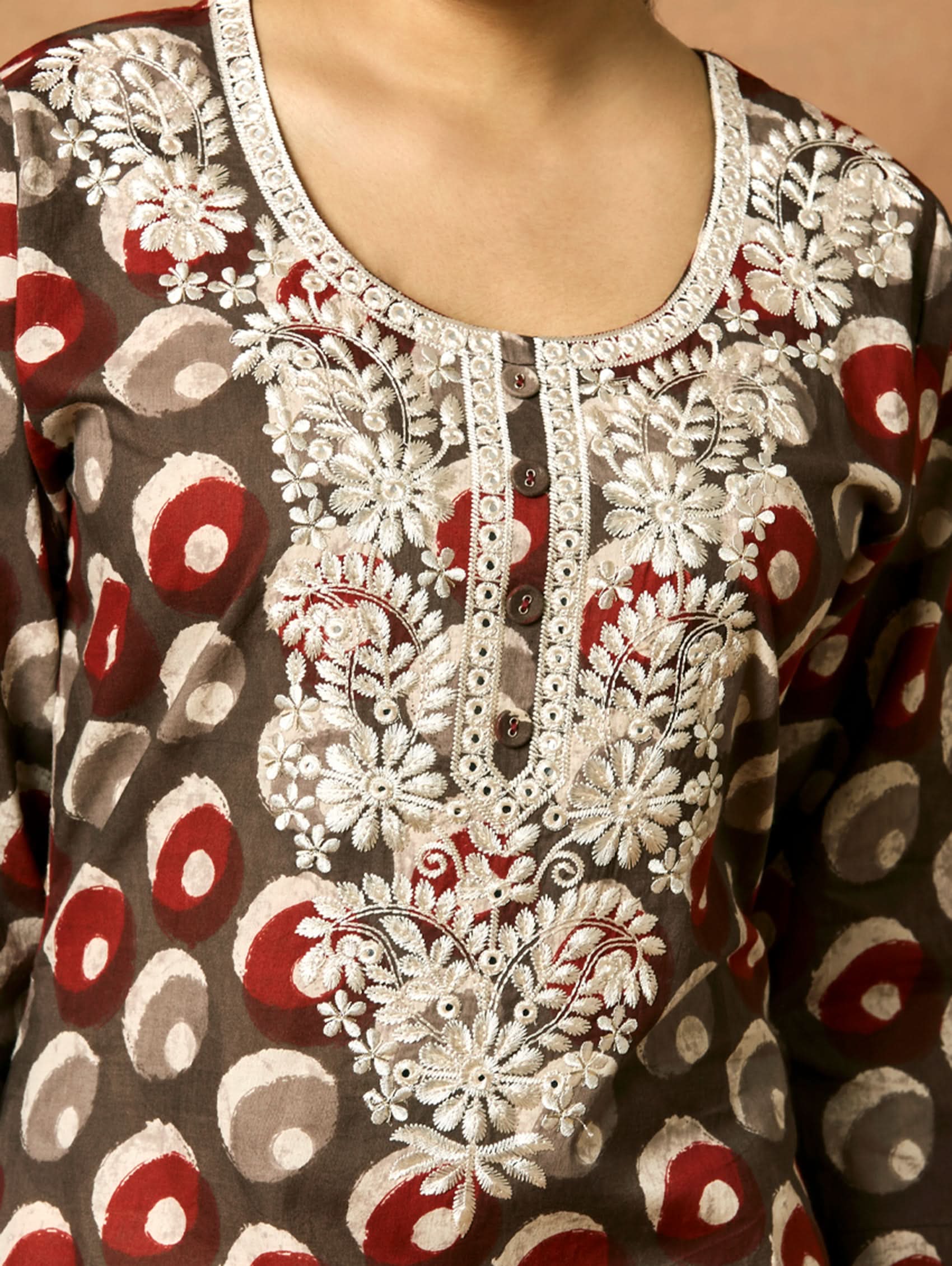 Close-up of a patterned garment with lace detailing.