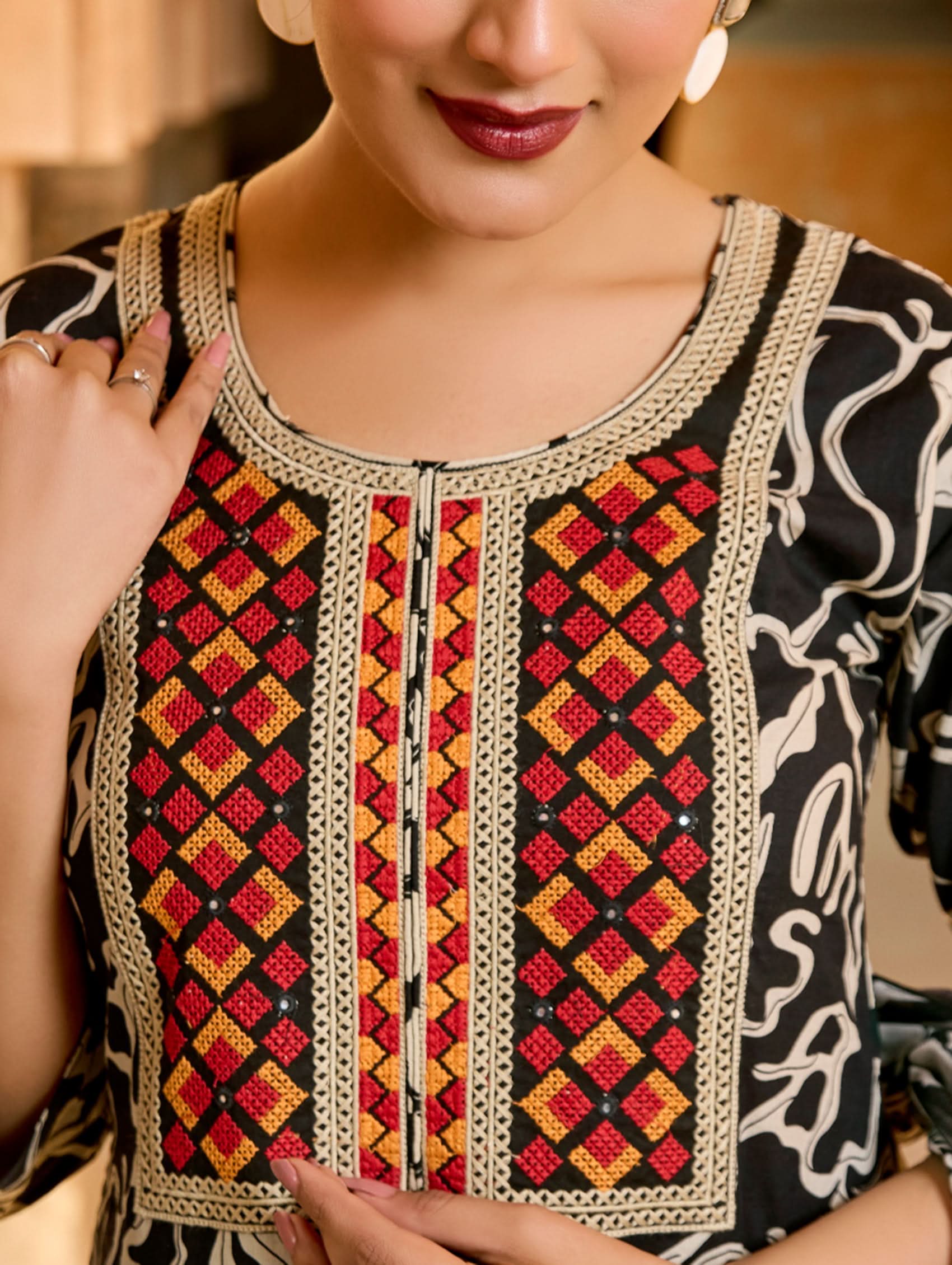 Close-up of a person wearing a traditional garment with intricate patterns.