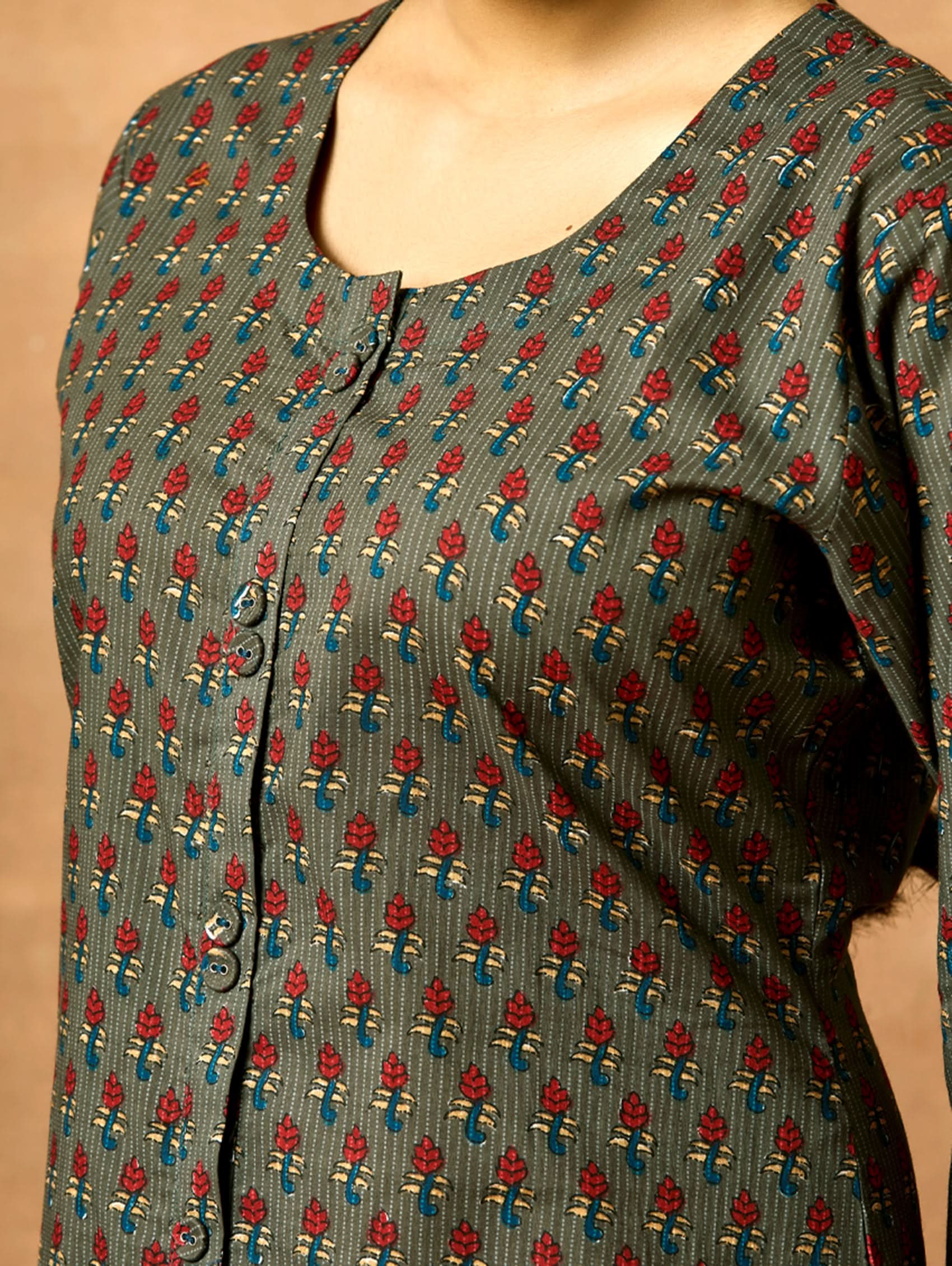 A woman plus size model wearing a printed pure cotton kurta with round neckline, three-fourth sleeves, and side slits. The kurta is in shades of gray and blue with a geometric pattern.
