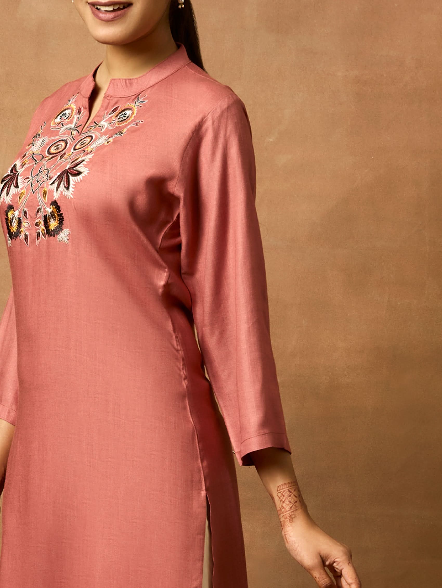 Pink kurta with embroidery on a brown background