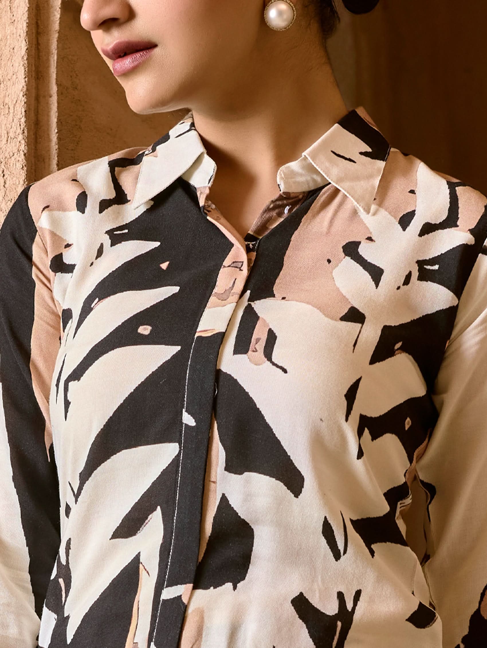 Women wearing a printed Co ord set with shirt collar neck style with ankle length pant