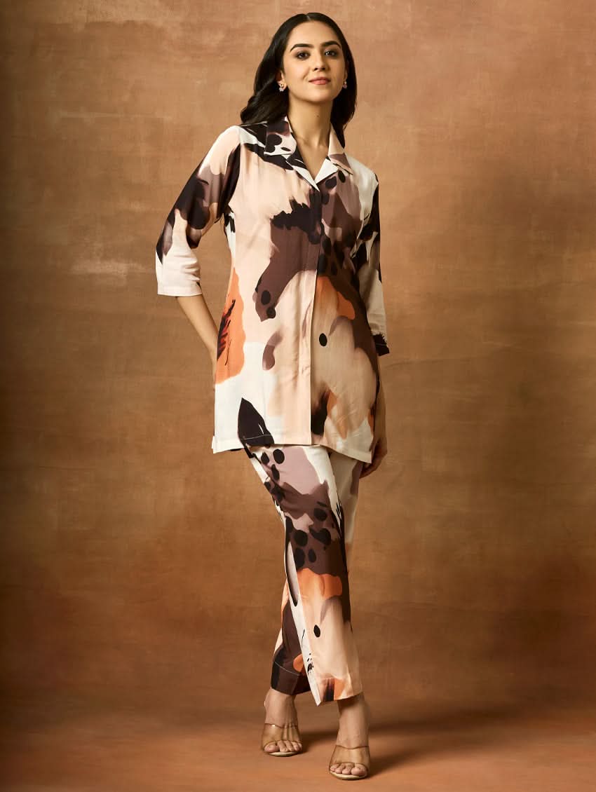 A woman modeling a digitally printed viscose rayon co-ord set with a short kurta in a camouflage pattern and regular pants.