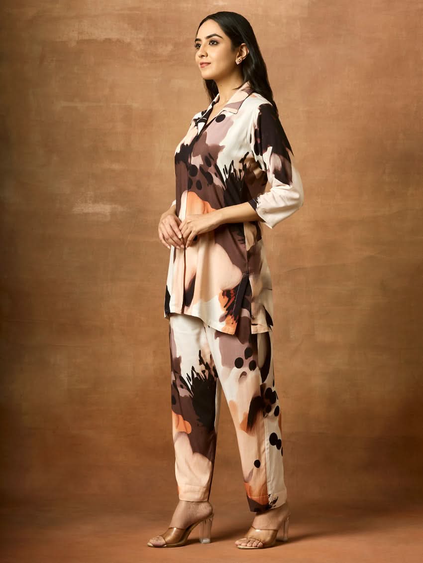 Woman wearing a patterned outfit against a brown background