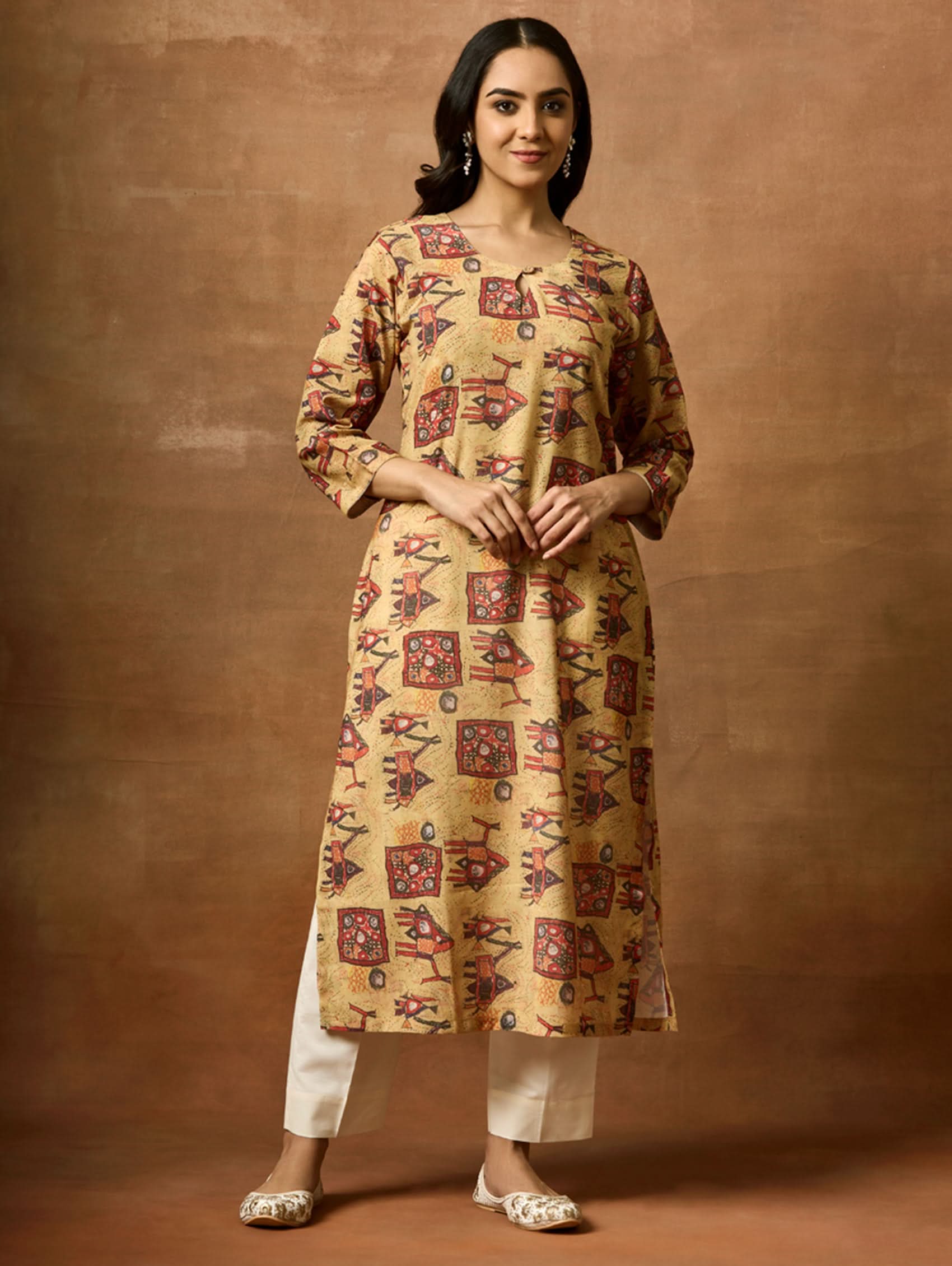 A woman plus size model wearing a beige and red printed viscose rayon kurta with round neckline, three-fourth sleeves, and side slits.