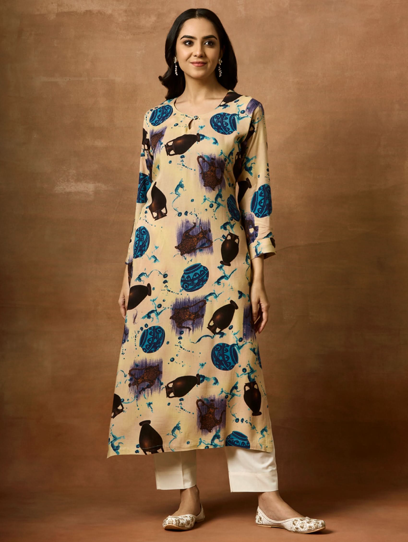 A woman plus size model wearing a beige kurta with animal prints, round neckline, and three-fourth sleeves.