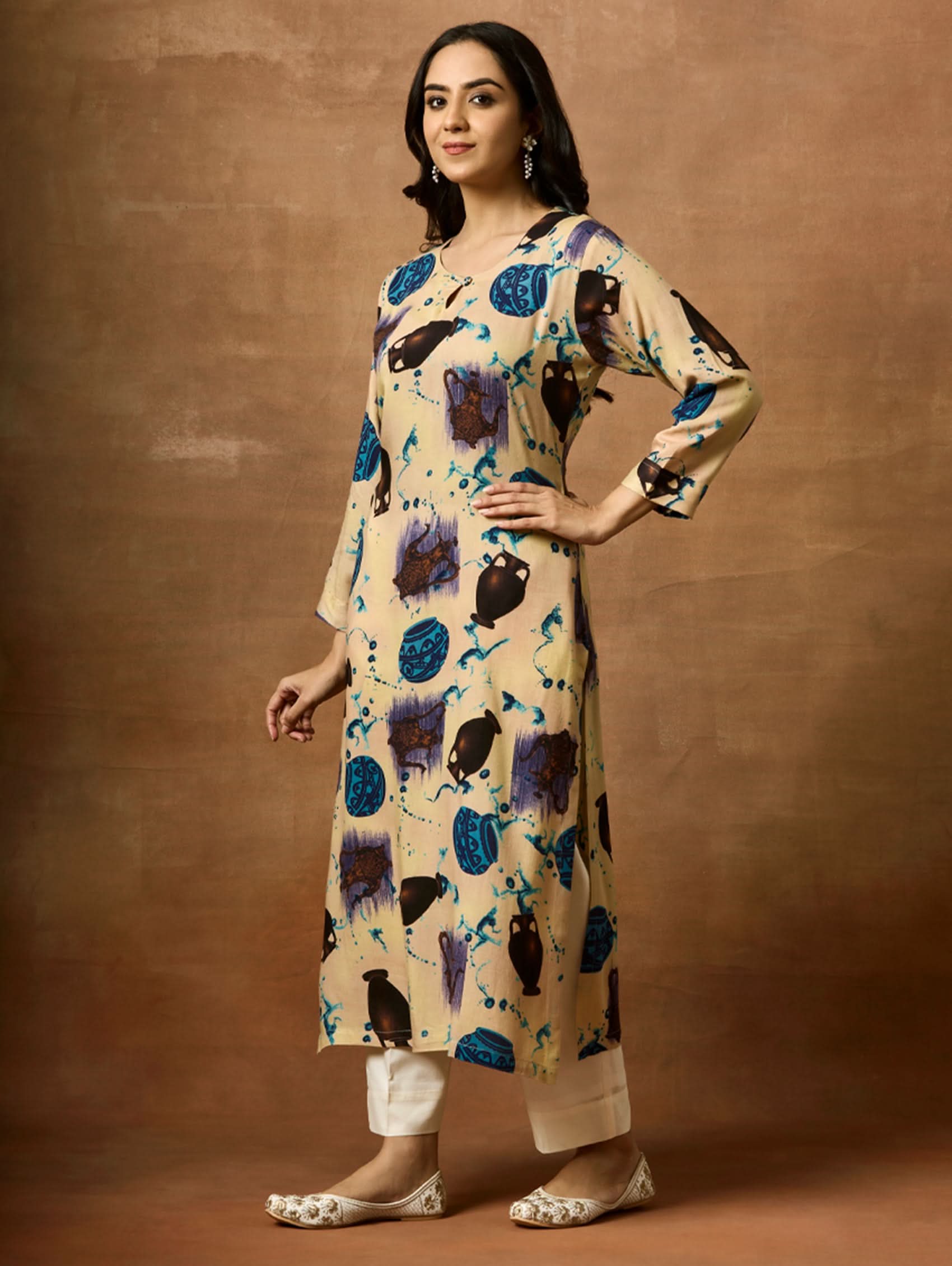 A woman plus size model wearing a beige kurta with animal prints, round neckline, and three-fourth sleeves.