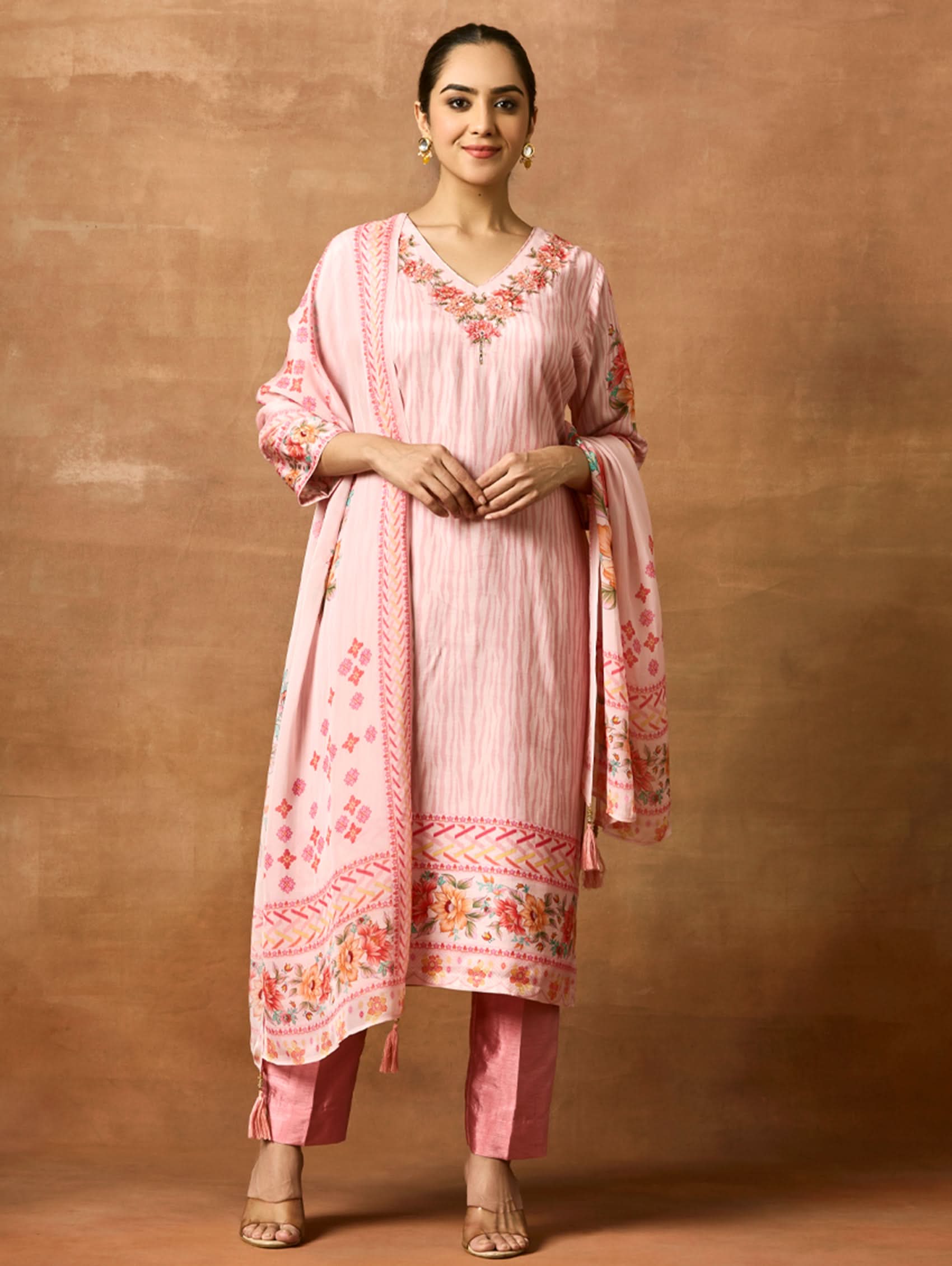 A woman modeling a pink and red digitally printed pure viscose muslin silk suit set with a kurta, pants, and a dupatta.