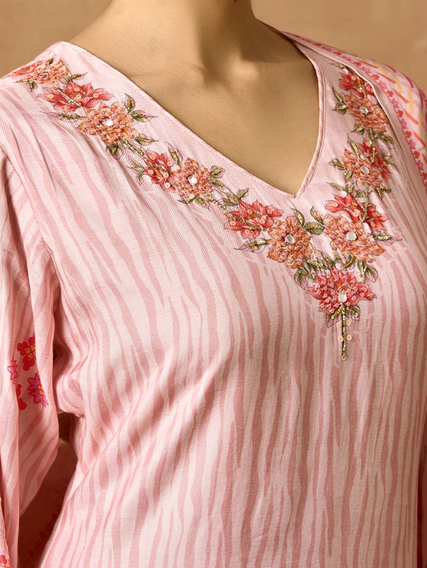 A woman modeling a pink and red digitally printed pure viscose muslin silk suit set with a kurta, pants, and a dupatta.