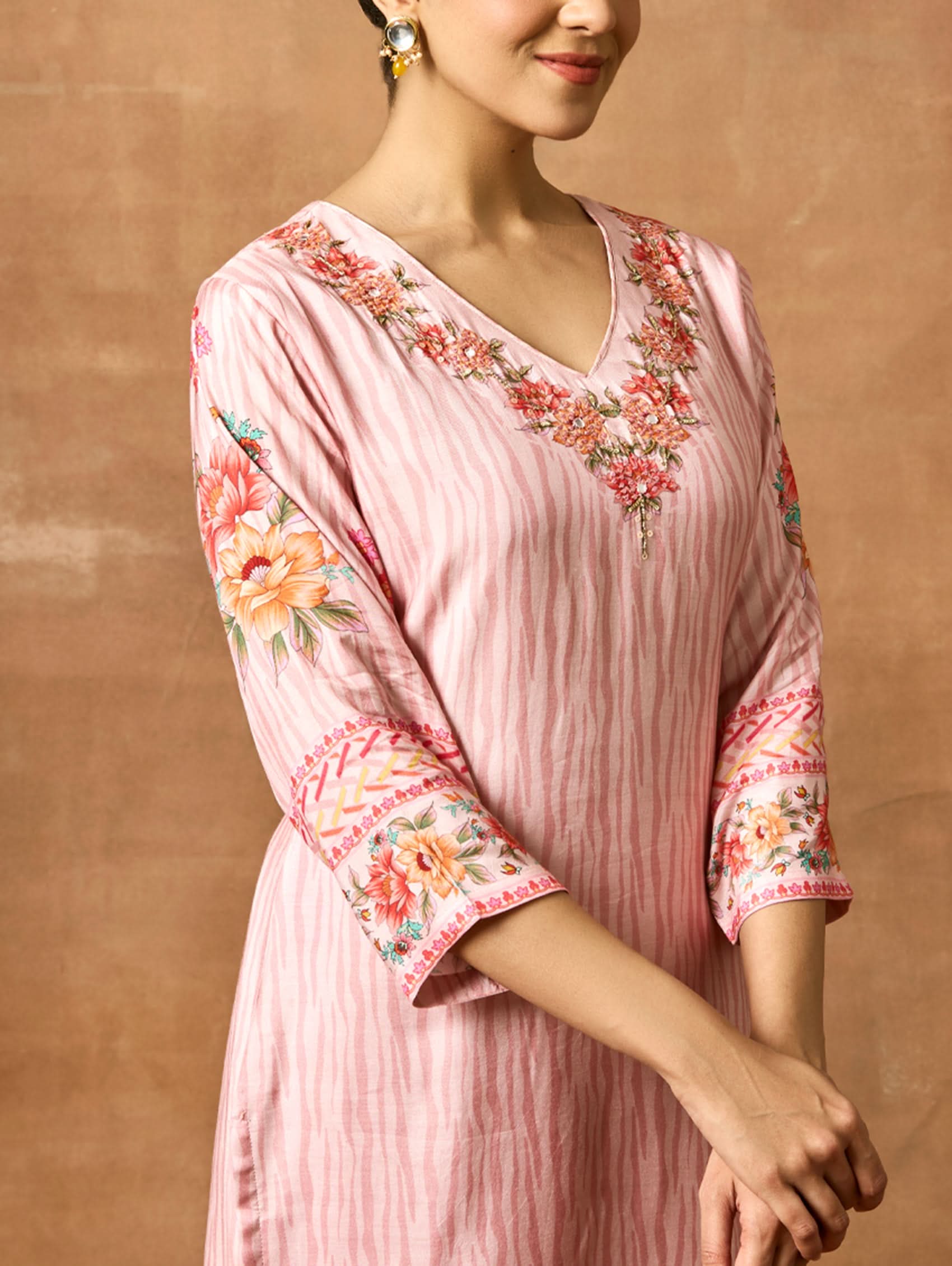 A woman modeling a pink and red digitally printed pure viscose muslin silk suit set with a kurta, pants, and a dupatta.