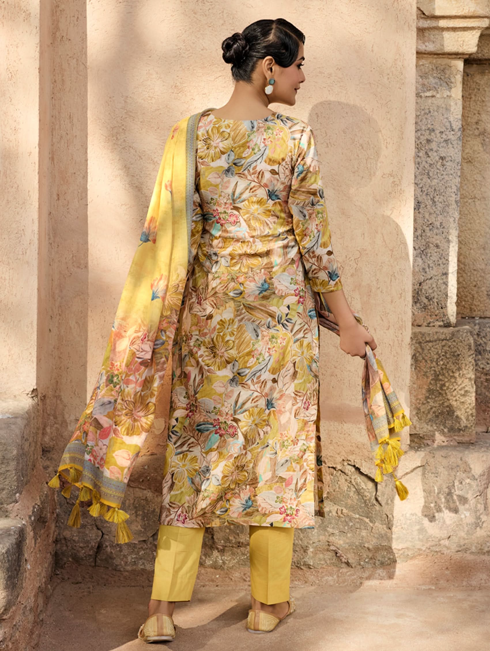 A woman wearing a yellow and multicolor embroidered pure malai cotton suit set with a kurta, pants, and a dupatta.
