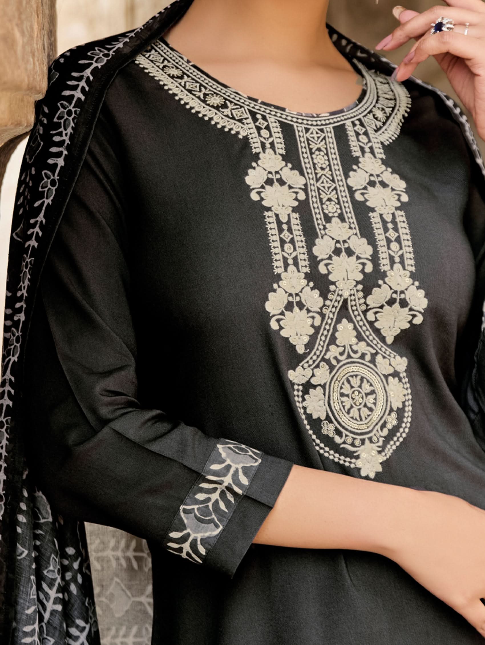 Black garment with intricate white embroidery