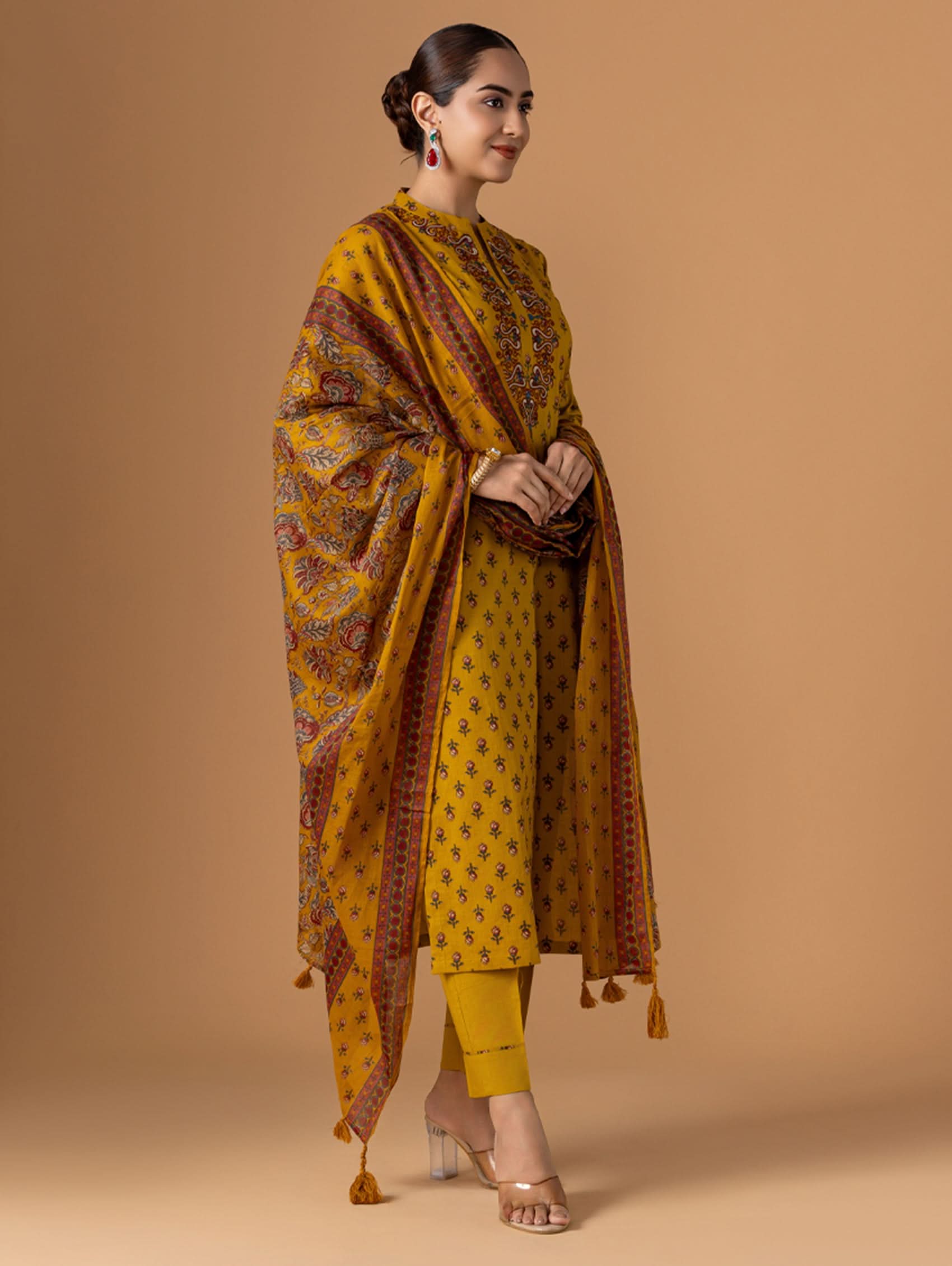 Embroidered yellow cotton suit set with draped dupatta and tassel trim