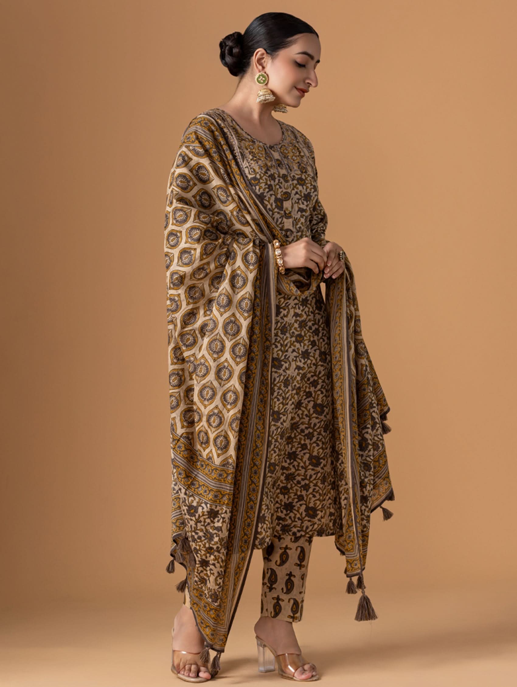 Woman wearing a patterned outfit against a beige background
