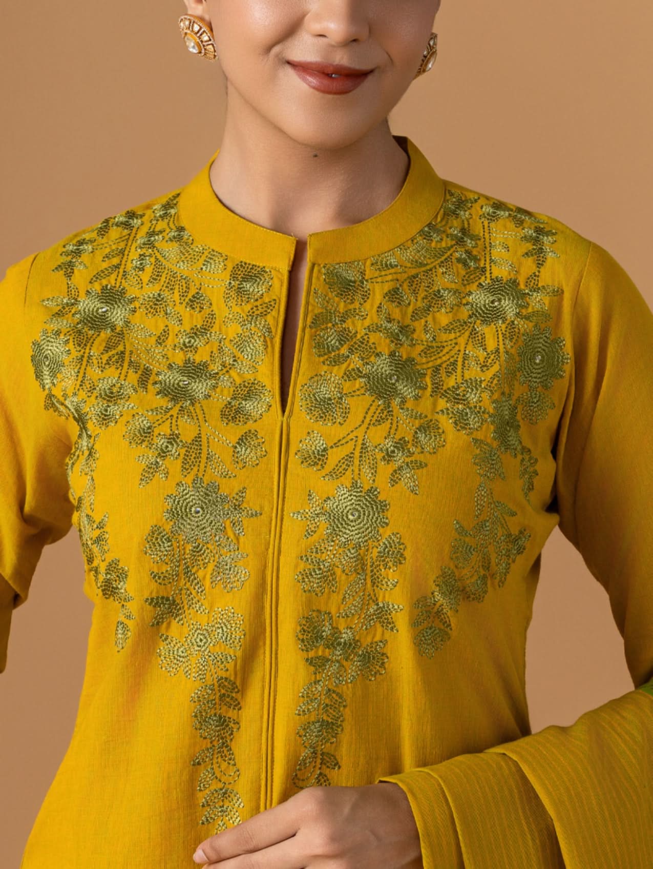 Yellow embroidered outfit with a plain background