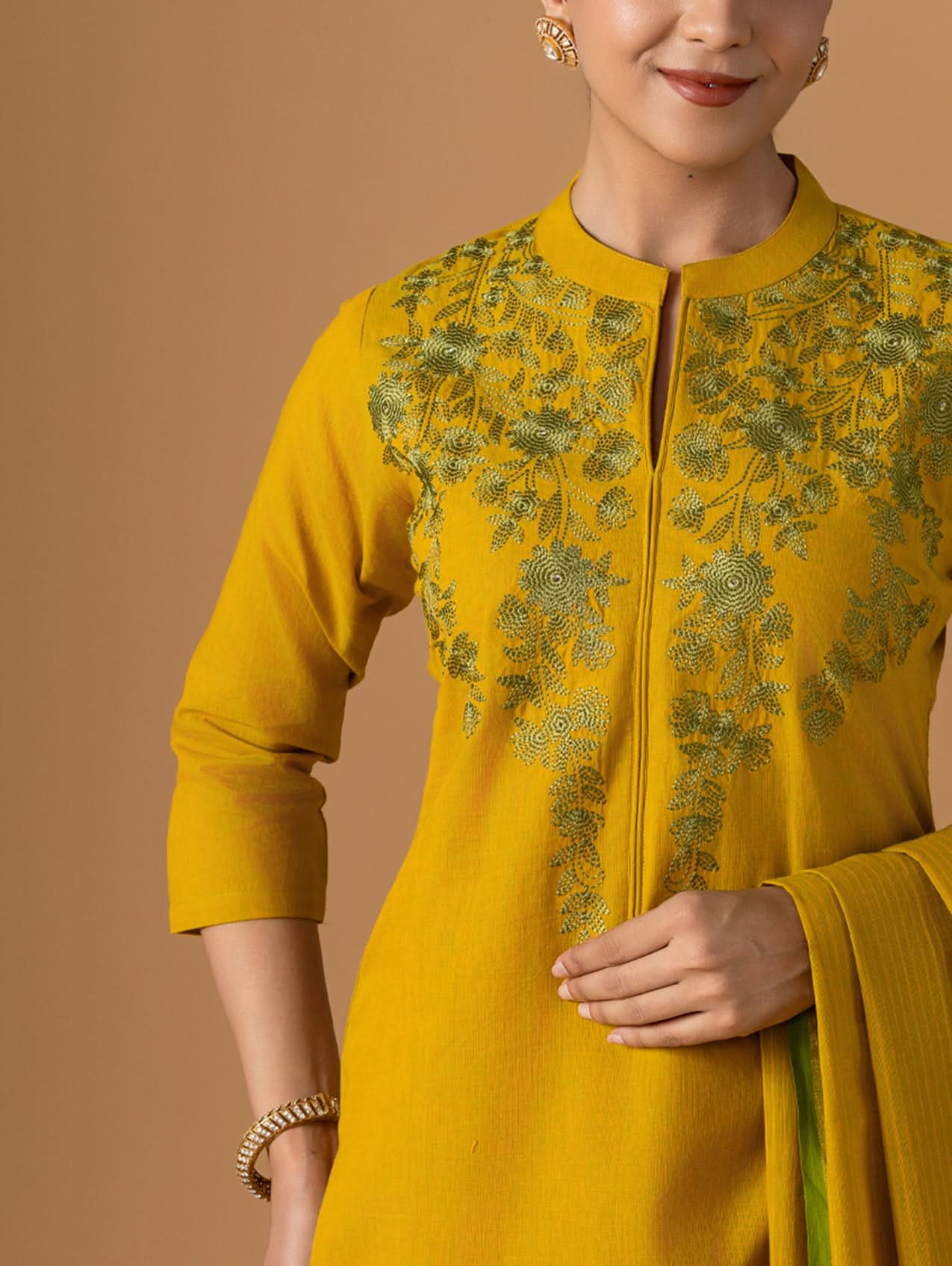 Yellow embroidered kurta with a plain background