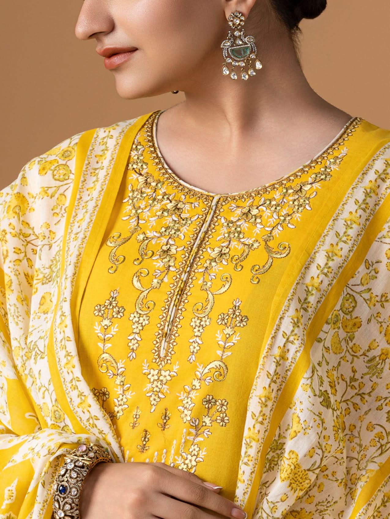 Yellow and white embroidered traditional outfit with intricate patterns