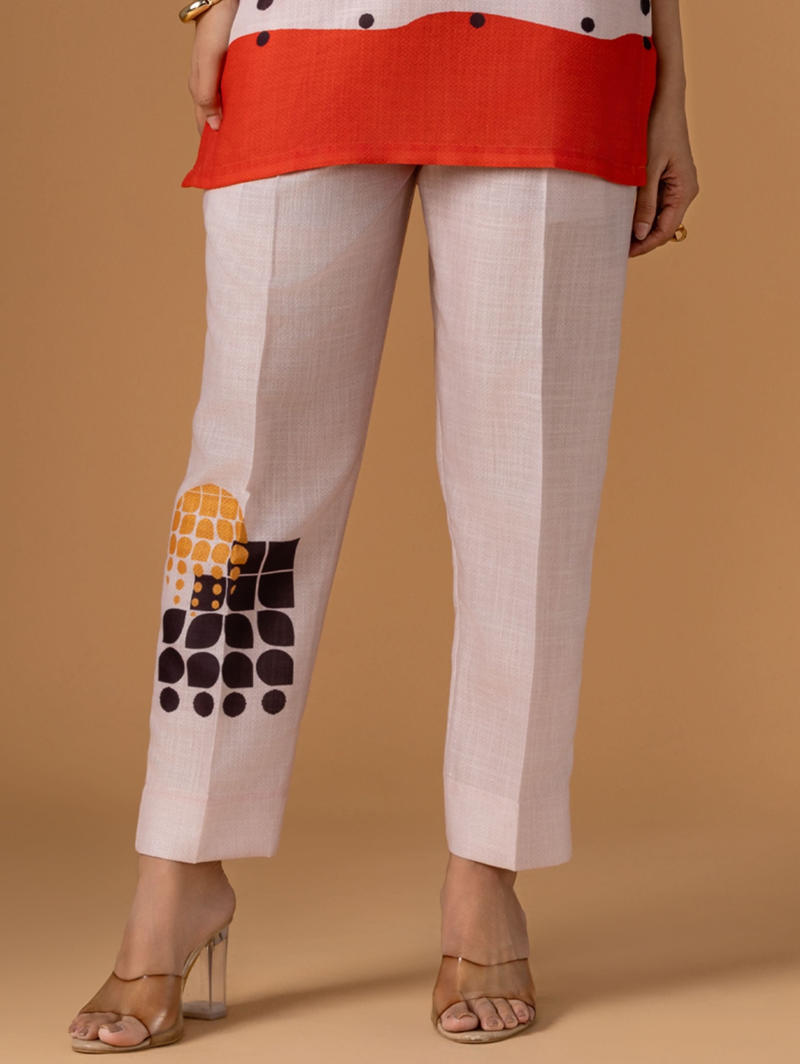 Beige pants with geometric pattern on a brown background
