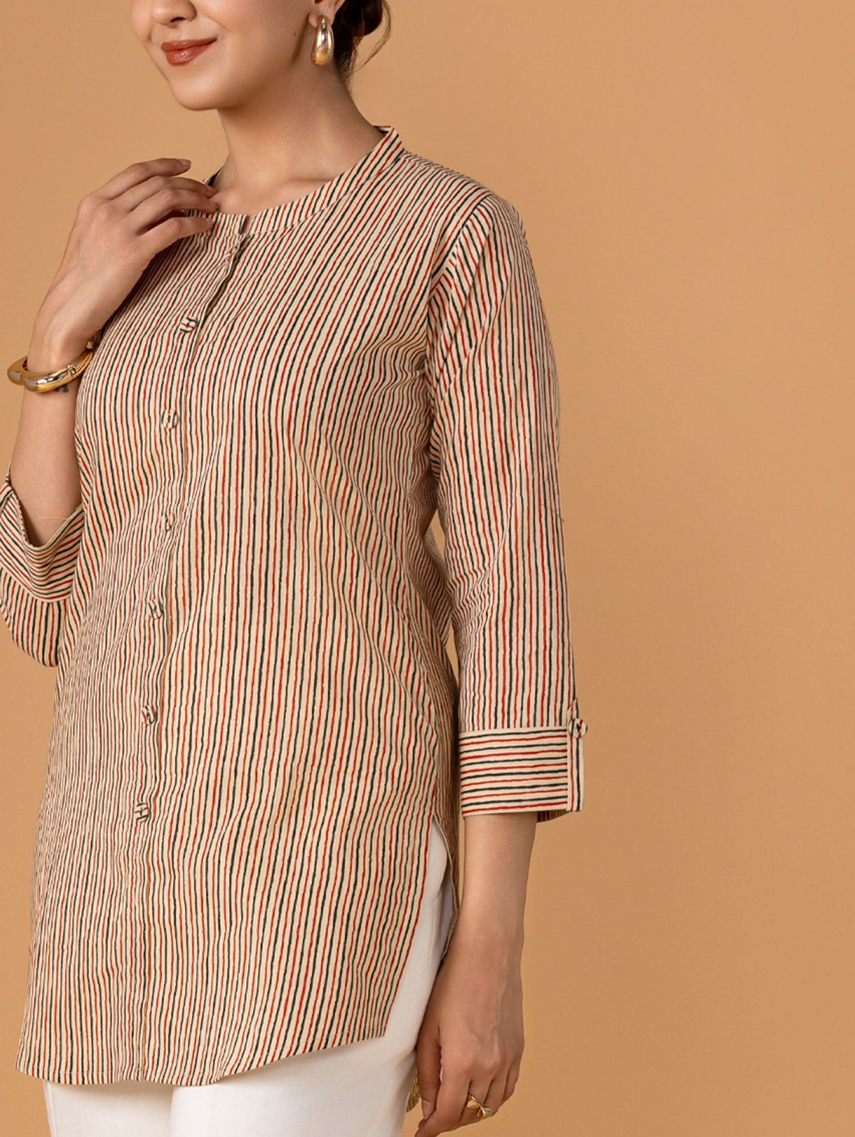 Woman wearing a striped shirt with a plain background
