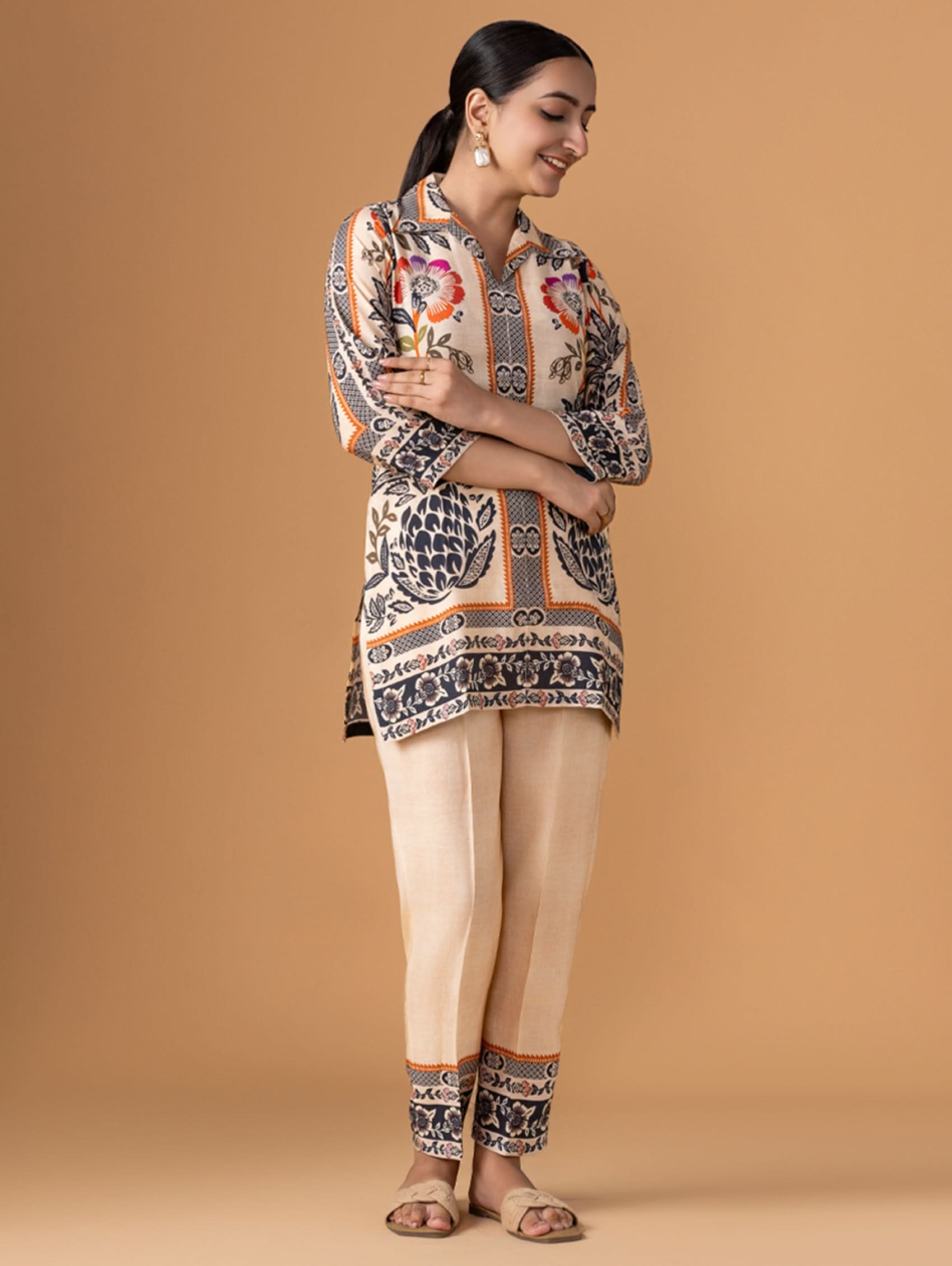 Woman wearing a patterned outfit on a beige background