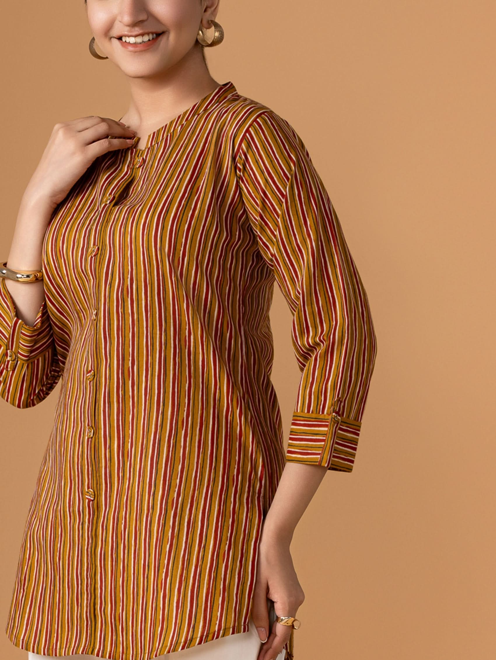 Woman wearing a striped shirt against a brown background
