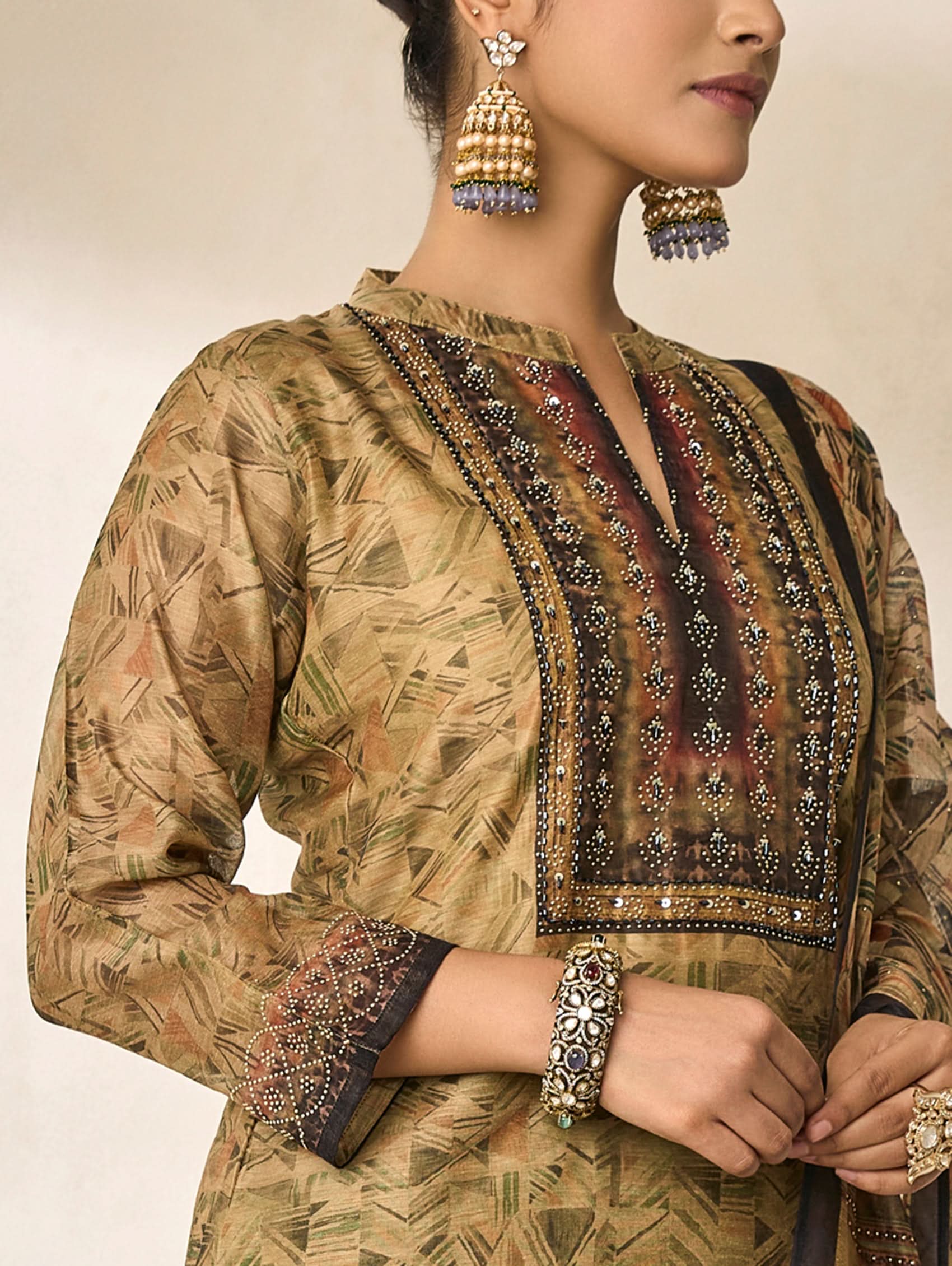 Traditional outfit with intricate patterns and embellishments on a neutral background